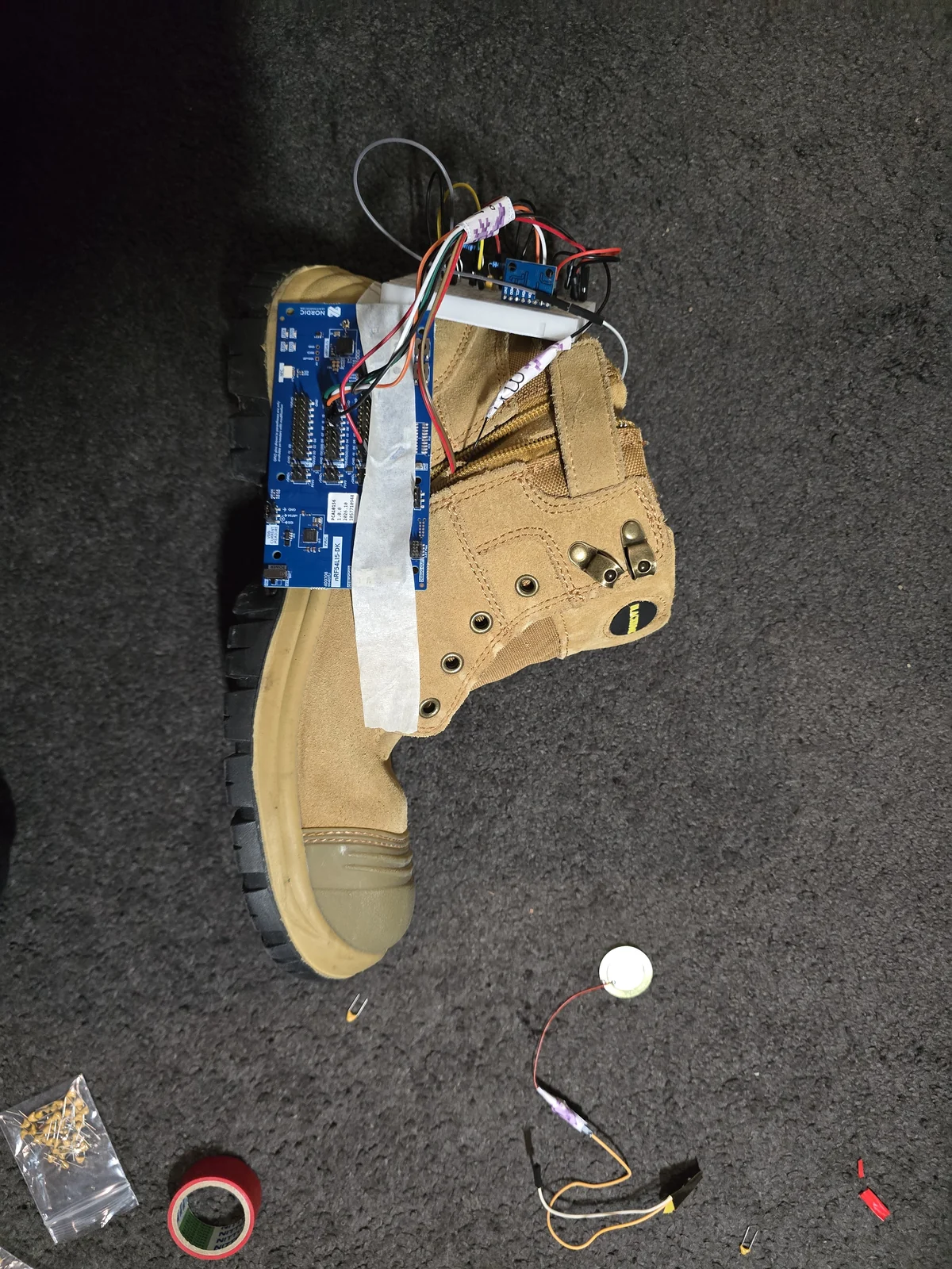 An early shoe-based prototype with a tan insole and exposed electronics
