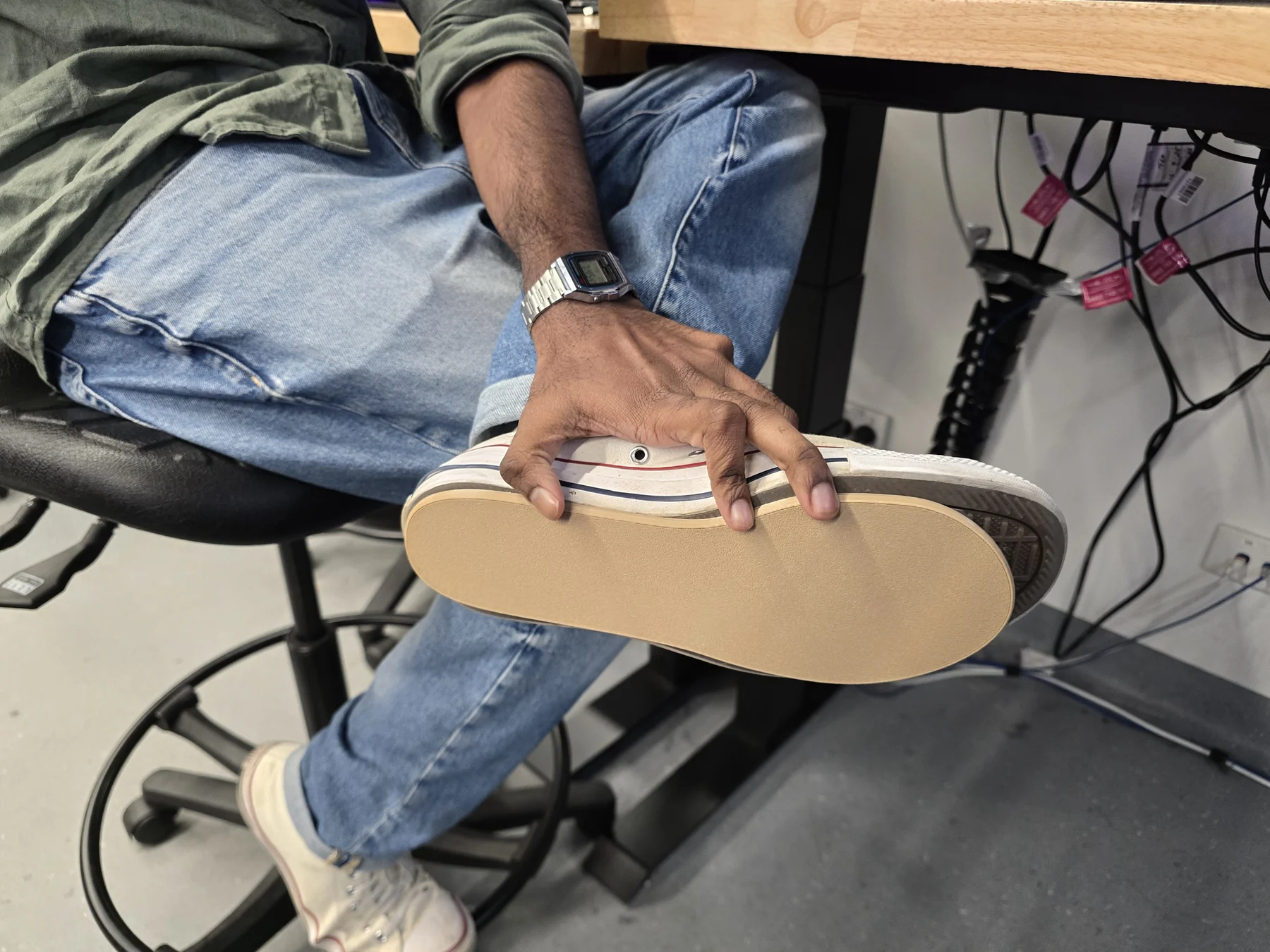 A team member bending a shoe and prototype insole to explore flexibility