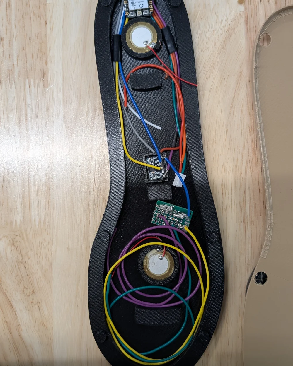 Heel and forefoot sensors, motion sensor and wiring inside an early black insole