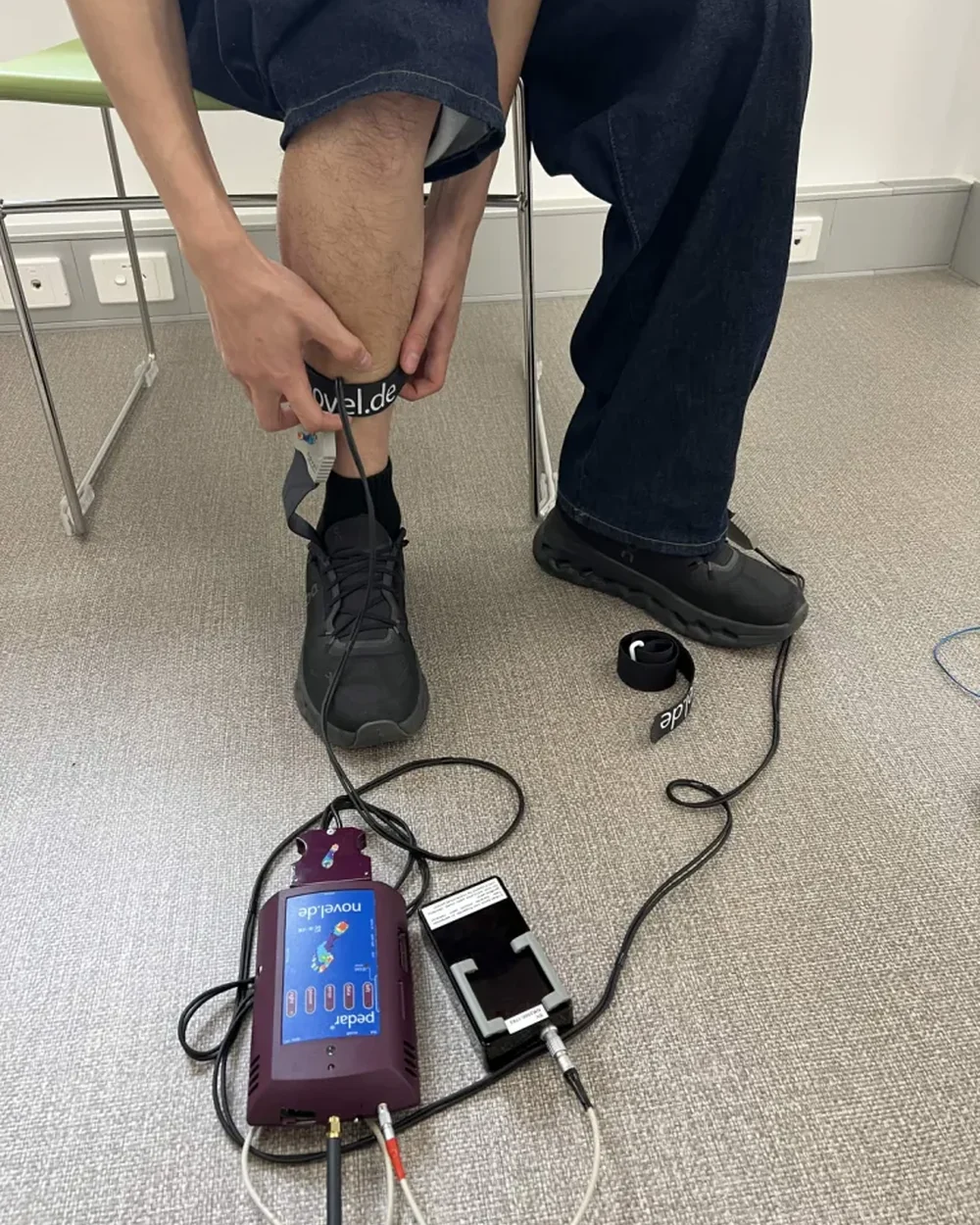 A team member fitting wearable reference equipment before a walking session